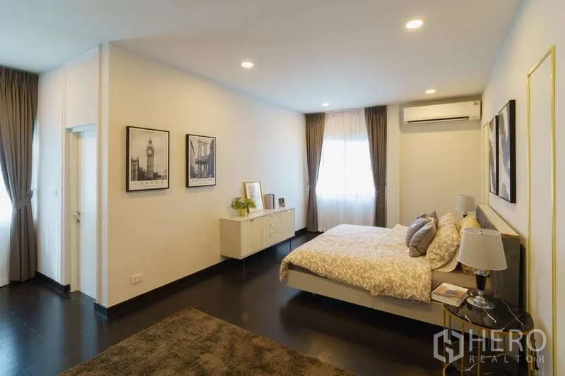 Detached House for rent or sale in Bang Phli, Samut Prakan - Airy bedroom with bed, two windows and air-conditioning.