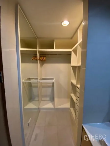 Condominium for rent or sale - Walk-in closet with built-in shelves, drawers and hanging space.