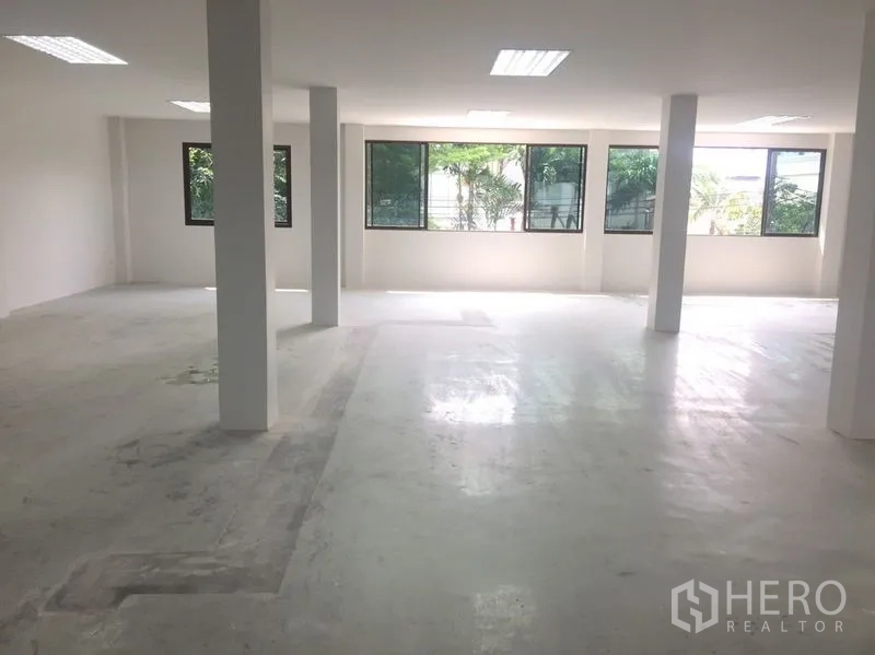Home Office for rent in Watthana, Bangkok - Bright upper floor office space with multiple windows and ceiling lights.