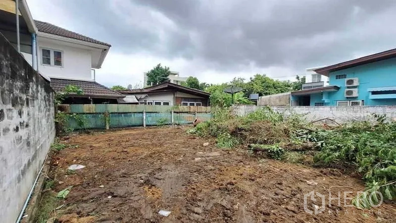 ที่ดิน ขายในKhlong Toei, Bangkok - แปลงที่ดินถมเรียบ มีกำแพงล้อม รายล้อมด้วยบ้านพักอาศัย ท้องฟ้าครึ้ม ใกล้ BTS เอกมัย