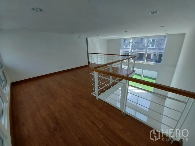 ทาวน์เฮาส์ ขายในWang Thonglang, Bangkok - ชั้นลอยปูพื้นไม้ ราวกันตกเหล็กผสมไม้ มองลงสู่ห้องนั่งเล่น