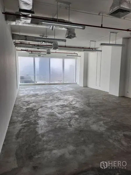 Office Space for rent in Sathon, Bangkok - Unfurnished 78 sqm office with exposed ducting and floor-to-ceiling windows overlooking the Bangkok skyline in Sathorn.