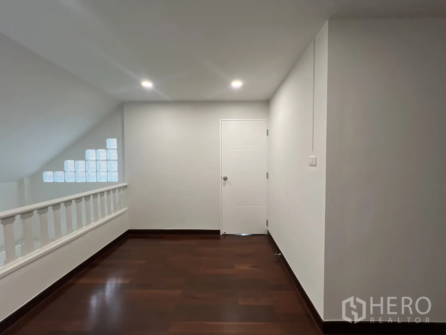 Detached House for rent in Saphan Sung, Bangkok - Upper landing with wooden flooring and white balustrade.