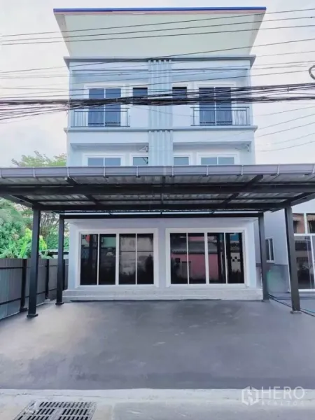 Home Office for rent in Bang Phli, Samut Prakan - Three-storey home office facade with covered parking and full-height sliding glass doors.