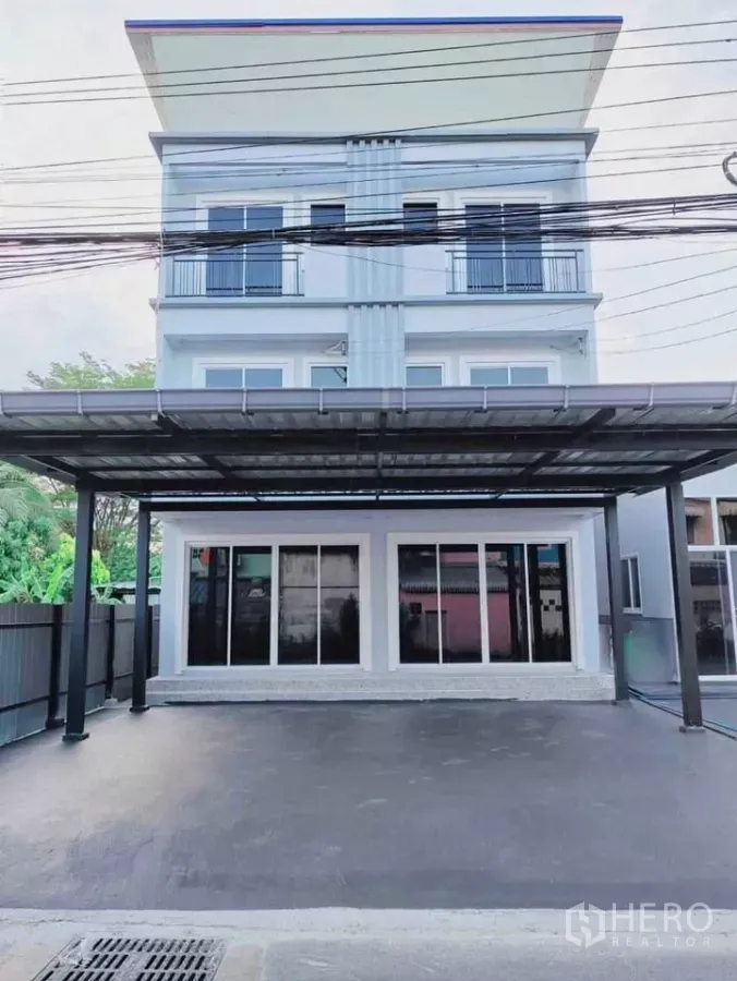 Home Office for rent in Bang Phli, Samut Prakan - Three-storey home office facade with covered parking and full-height sliding glass doors.