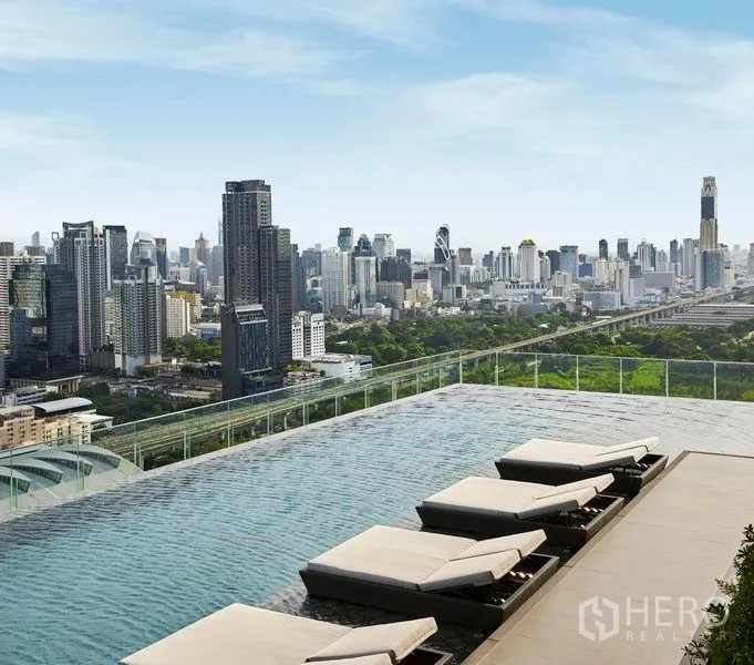公寓 出售在Ratchathewi, Bangkok - 屋顶泳池配躺椅，视野通透的城市全景。
