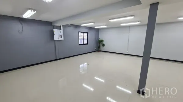 Home Office for rent in Pathum Thani - Open office room featuring windows, electrical panel and polished tile flooring.