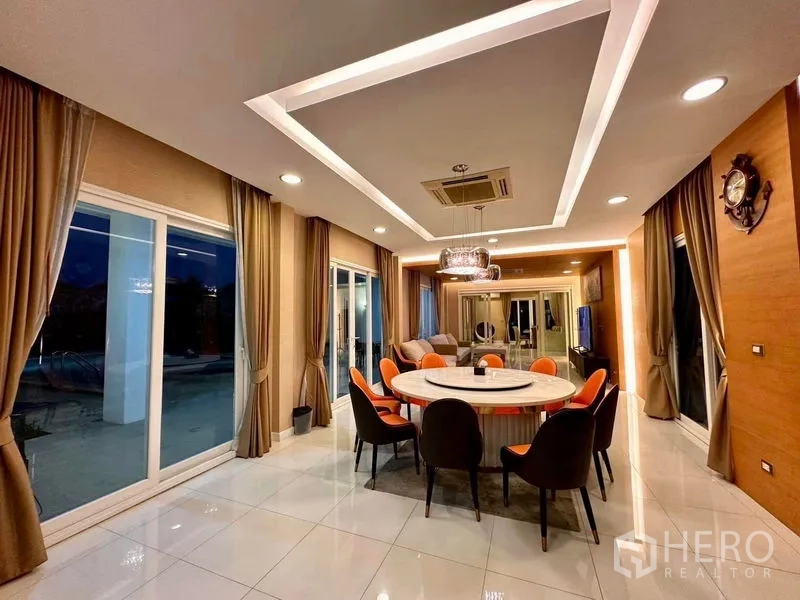 Detached House for rent or sale in Bang Phli, Samut Prakan - Night view of dining room with round table and feature ceiling