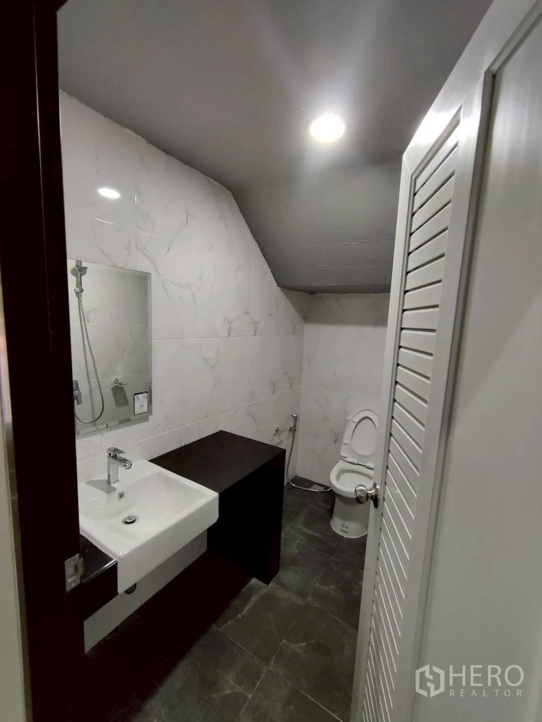 工厂 for rent in Krathum Baen, Samut Sakhon - 现代化卫生间，墙面瓷砖、洗手盆、镜子与坐便器。