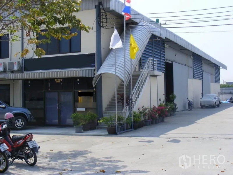 คลังสินค้า ให้เช่าในSaphan Sung, Bangkok - ด้านหน้าโกดังมีบันไดภายนอกพร้อมกันสาด ประตูม้วนหลายจุด และทางเข้า-ออกสำหรับรถบรรทุกกว้าง