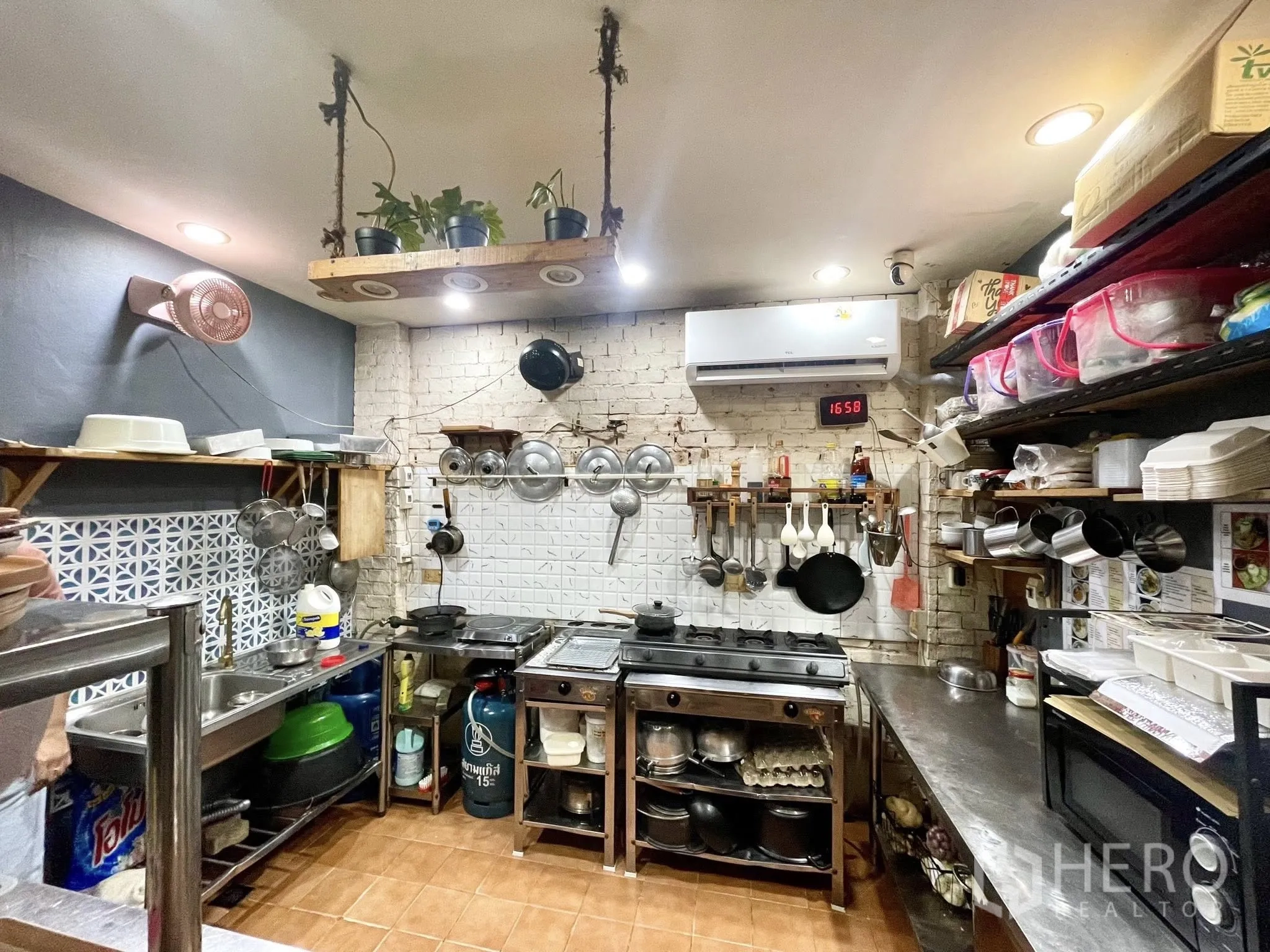 零售空间 for rent in Watthana, Bangkok - 商用厨房，燃气灶、不锈钢操作台、墙上搁架与空调。