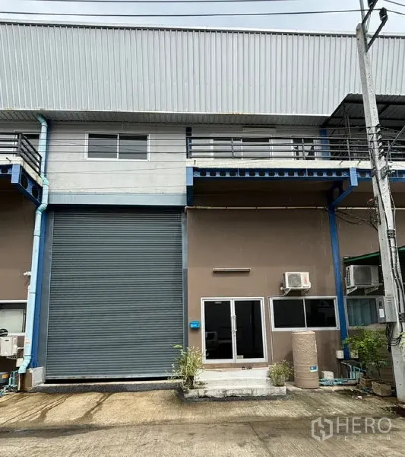 Warehouse for rent in Krathum Baen, Samut Sakhon - Front elevation of the warehouse showing roller shutter and glass door.