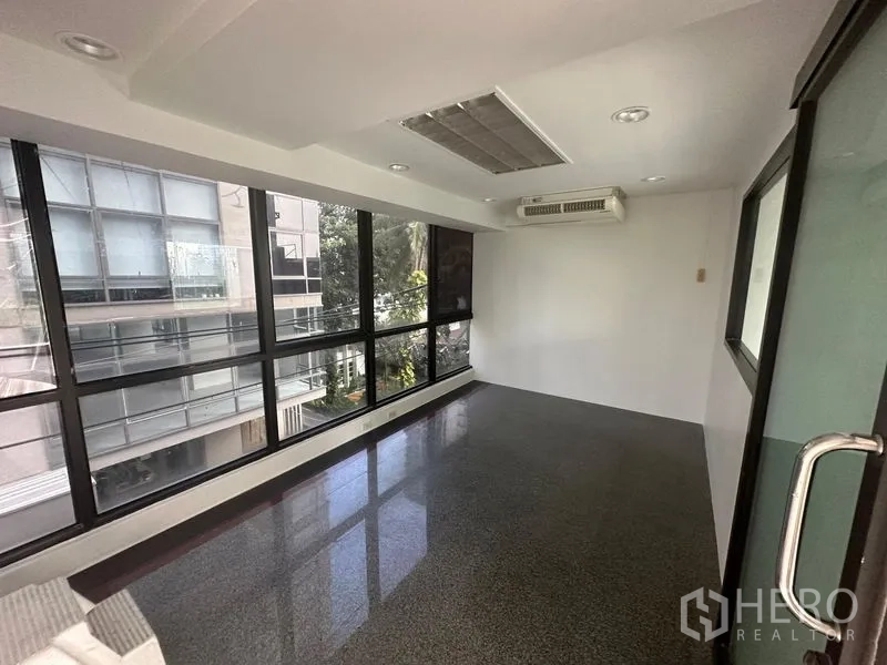 Office Space for rent in Sathon, Bangkok - Compact office room with large windows, wall air-conditioning and polished granite floor overlooking the city.