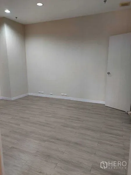 Retail Space for rent in Sathon, Bangkok - Open room with recessed ceiling lights, laminate flooring and multiple wall power outlets.