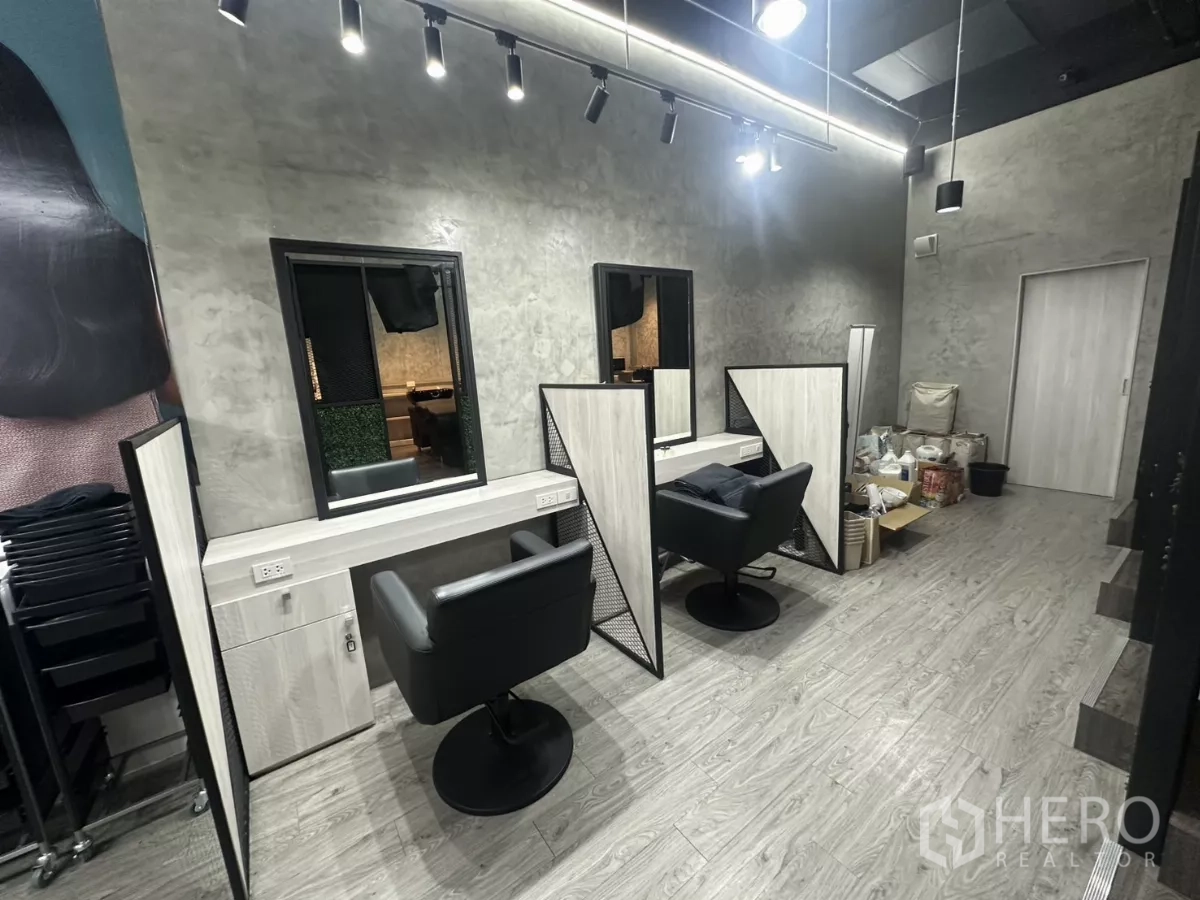 Retail Space for rent in Mueang Nakhon Pathom, Nakhon Pathom - Styling station with mirror, black chair and concrete-finish wall inside the retail unit.