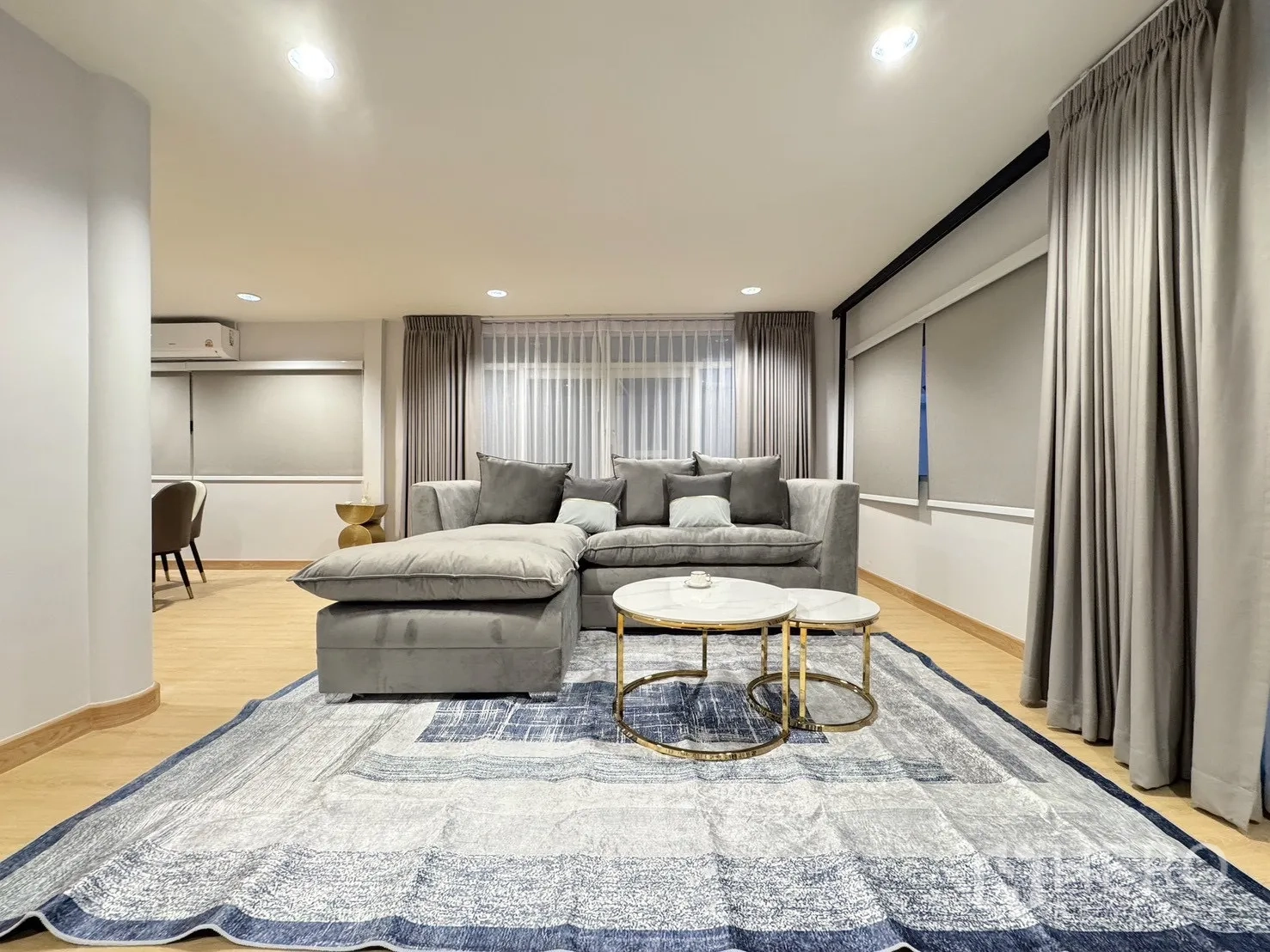 Detached House for rent - Bright living room with gray sectional sofa, marble coffee tables and large rug.