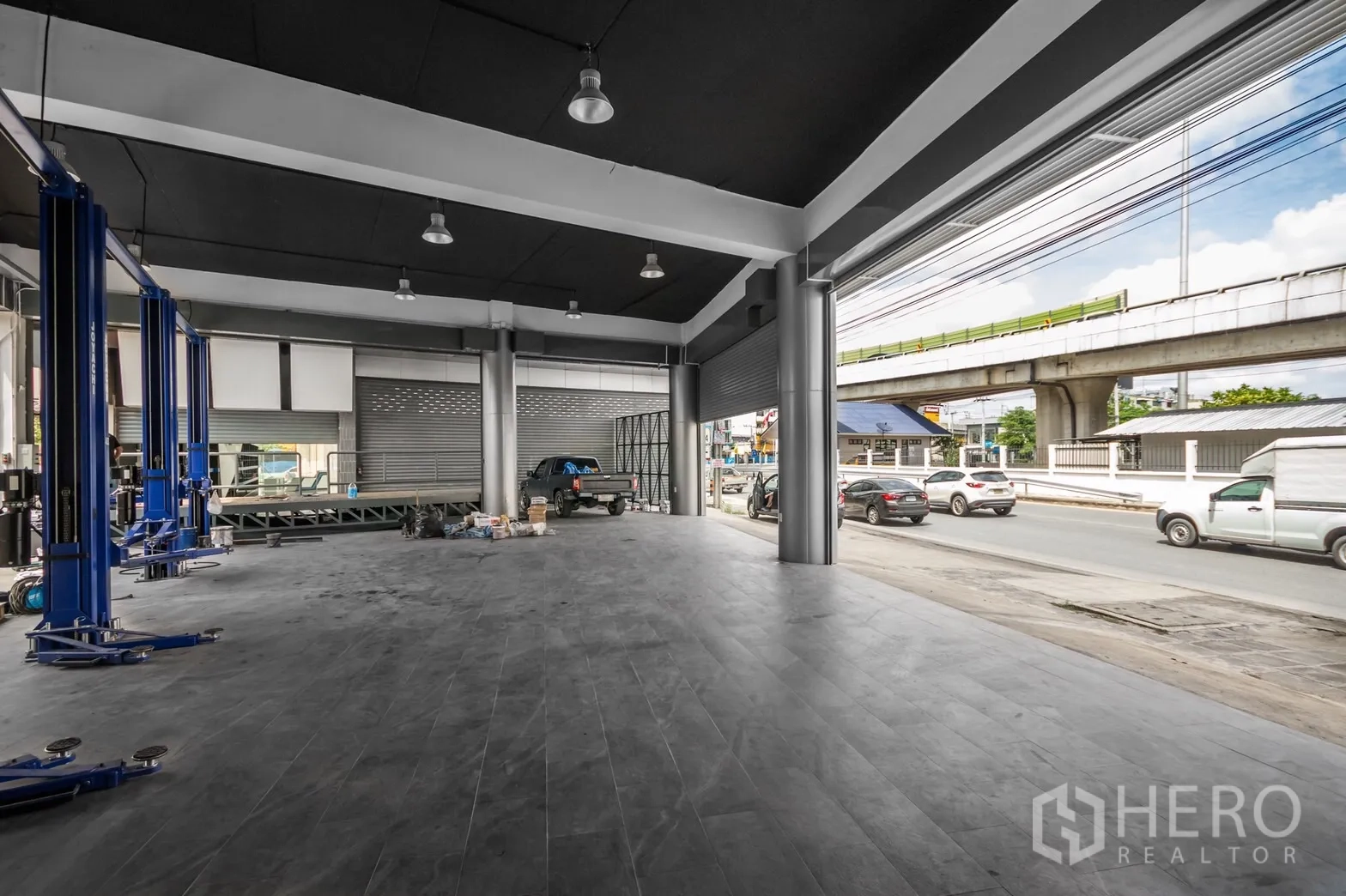 展厅 出租在Khan Na Yao, Bangkok - 开阔的维修/展示空间，多道卷帘门与明亮照明，可驾车进出。