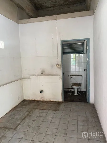 Office Space for sale in Wang Thonglang, Bangkok - Basic utility area with a sink and a small restroom needing upgrade.