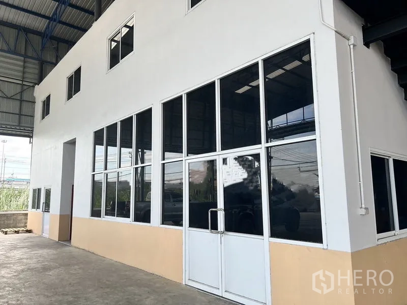 Warehouse for rent in Lat Krabang, Bangkok - Glass-fronted internal office block with double doors and tinted windows inside the warehouse.