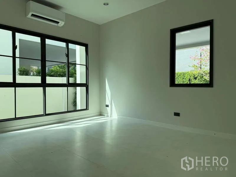 Detached House for rent or sale in Bang Phli, Samut Prakan - Ground-floor multipurpose room featuring wide windows and garden outlook.