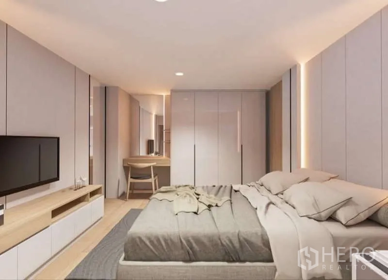 Condominium for rent in Huai Khwang, Bangkok - Spacious bedroom with wardrobes, work desk and TV opposite the bed.