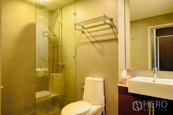 Condominium for rent in Watthana, Bangkok - Modern bathroom with glass shower enclosure, rain shower and vanity.