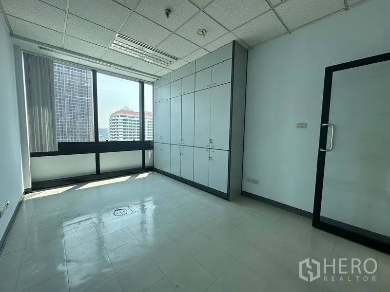Office Space for rent in Khlong Toei, Bangkok - Office room featuring a full wall of storage cabinets and city-view windows.