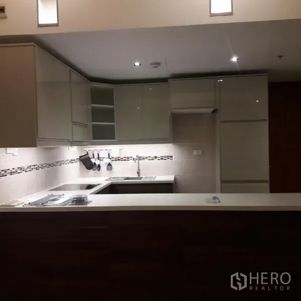 Condominium for sale in Sathon, Bangkok - Contemporary U‑shaped kitchen with built‑in appliances and ample storage.