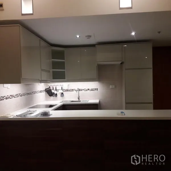 Condominium for sale in Sathon, Bangkok - Contemporary U‑shaped kitchen with built‑in appliances and ample storage.