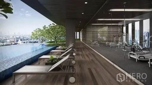 Condominium for rent or sale in Watthana, Bangkok - Rooftop infinity pool with sun loungers beside a glass-walled gym overlooking the skyline.