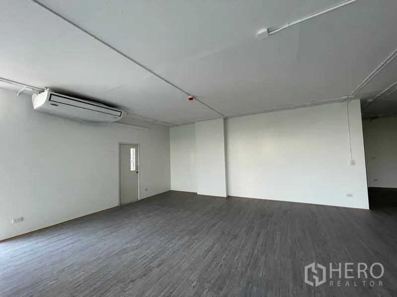 Office Space for rent in Bang Rak, Bangkok - Corner area with air-conditioning and a solid door beside a large window.