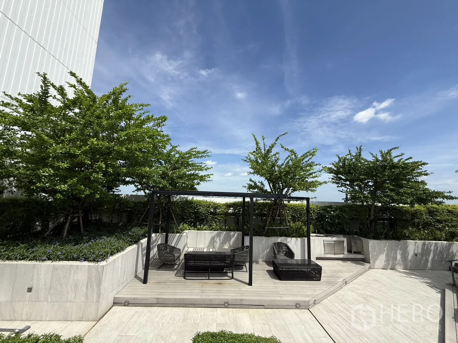 Condominium for sale in Chatuchak, Bangkok - Landscaped rooftop terrace with pergola seating and greenery.
