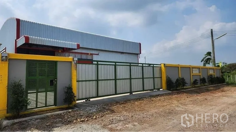 Warehouse for rent in Nong Chok, Bangkok - Front facade of the warehouse compound with secure sliding gates and perimeter fence.