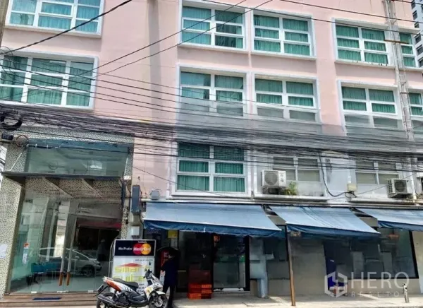 Shophouse for rent or sale in Khlong Toei, Bangkok - Multi-storey shophouse facade in Nana with large windows, awnings and streetfront power lines.