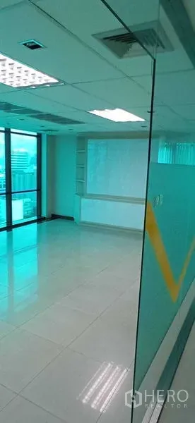 Office Space for rent in Huai Khwang, Bangkok - Open-plan office area with built-in shelving and large windows for natural light.