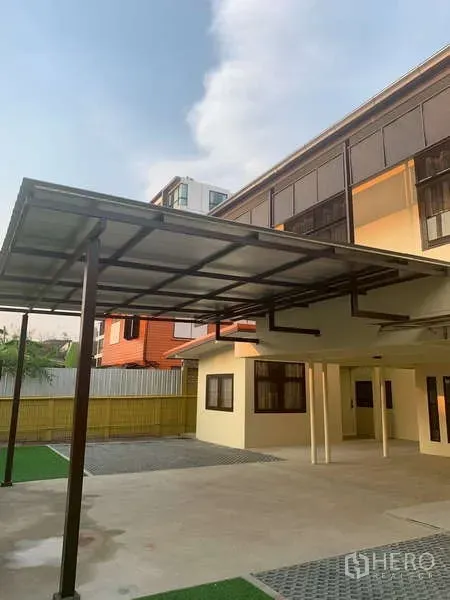 独立式住宅 出租或出售在Phra Khanong, Bangkok - 宽敞庭院与双车位有顶车棚，毗邻两层住宅。