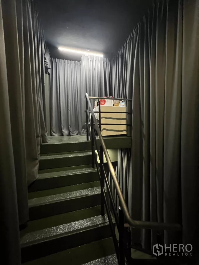 Retail Space for rent - Staircase wrapped with curtains connecting two levels.