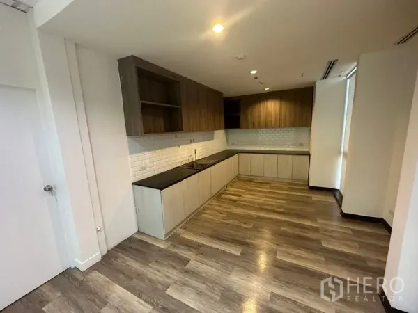 Office Space for rent - Modern office pantry with L-shaped countertop, wood cabinets, white subway tile backsplash and wood-look flooring.