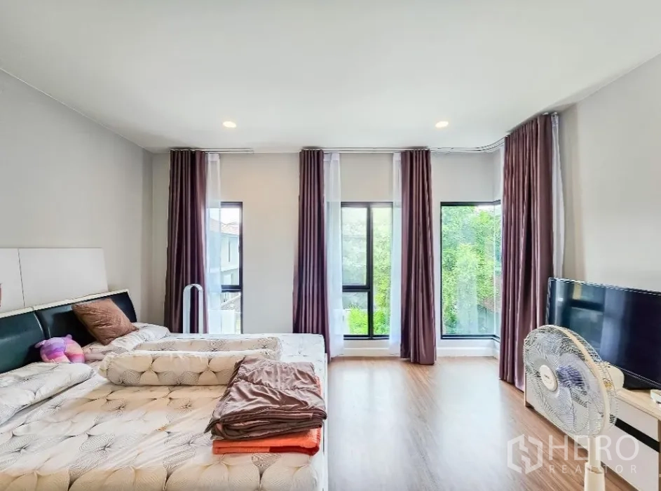 บ้าน ขายในLam Luk Ka, Pathum Thani - มุมมองจากห้องนอนใหญ่สู่หน้าต่างบานใหญ่ เห็นต้นไม้ภายนอก