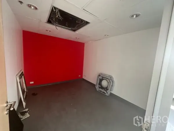 Office Space for rent in Khlong Toei, Bangkok - Small private office with red feature wall and suspended ceiling, Khlong Toei Ekkamai location.