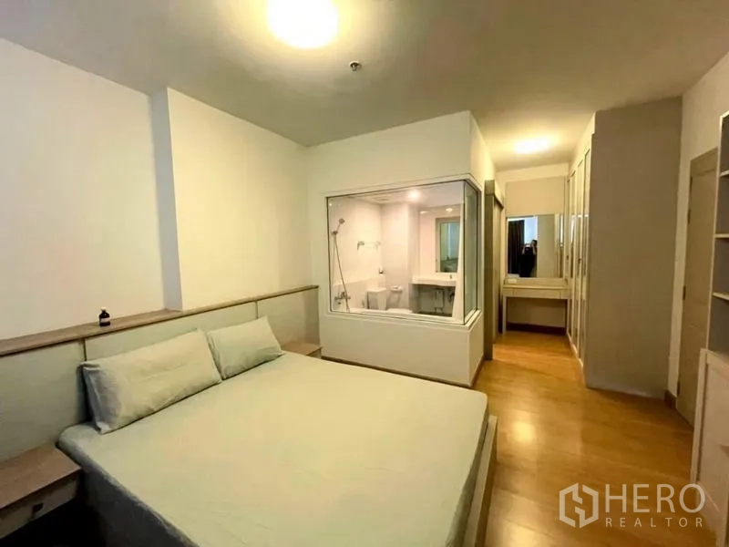 Condominium for sale - Master bedroom with king bed, glass-walled en-suite bathroom and ample wardrobes.