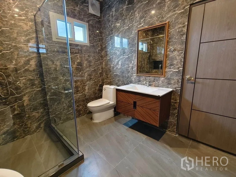 Detached House for rent or sale - Bathroom with glass shower, modern wood-finish vanity, and gray tiles.