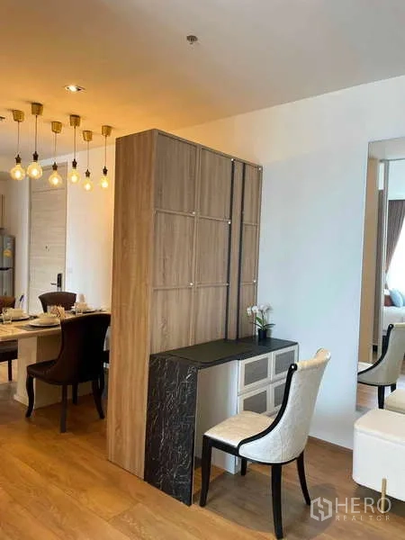 Condominium for rent or sale - Built-in wooden partition with storage and a compact work desk separating dining and living zones.