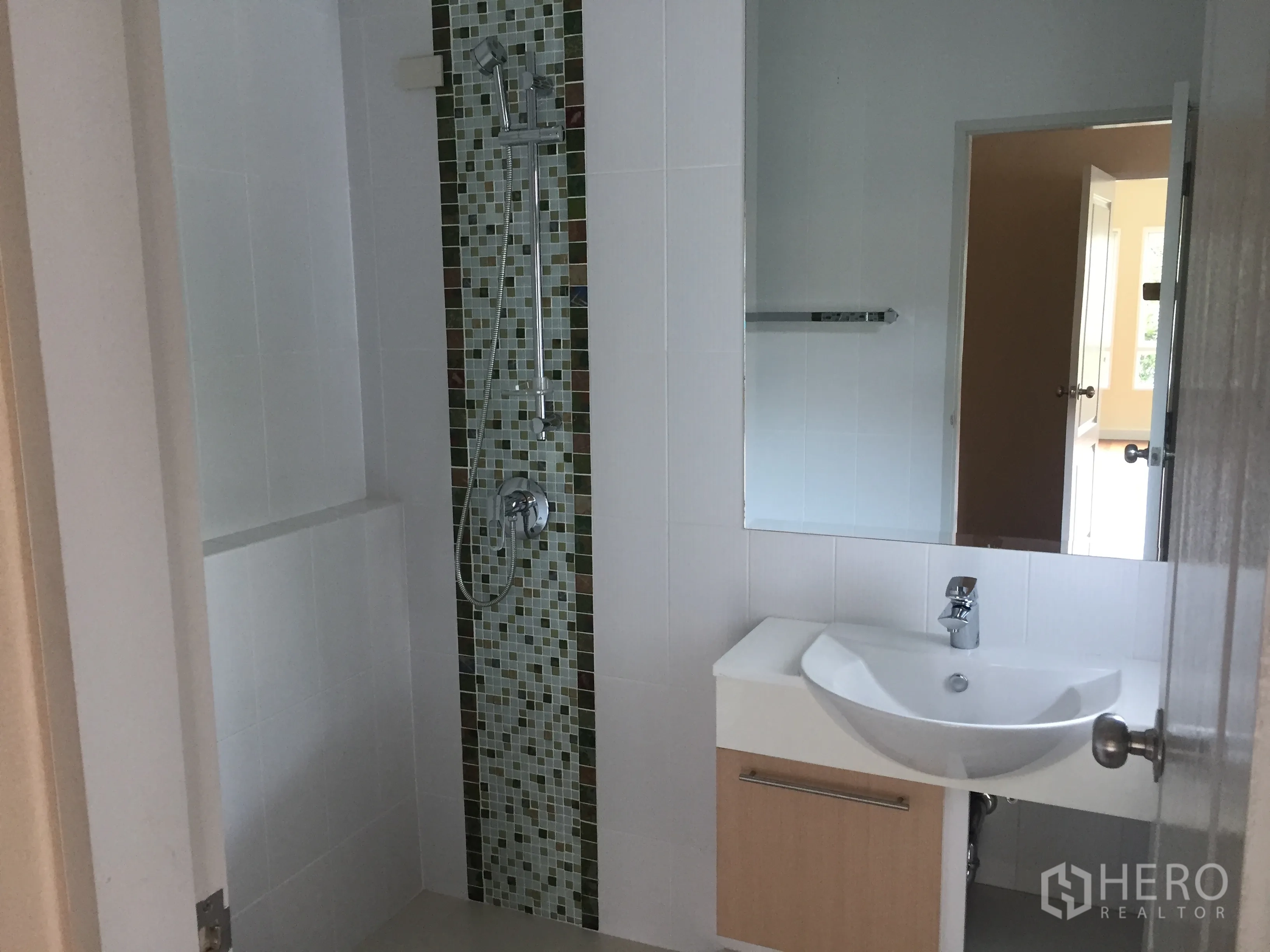 Detached House for sale in Saphan Sung, Bangkok - Modern bathroom featuring a mosaic-tile shower and sleek white vanity.