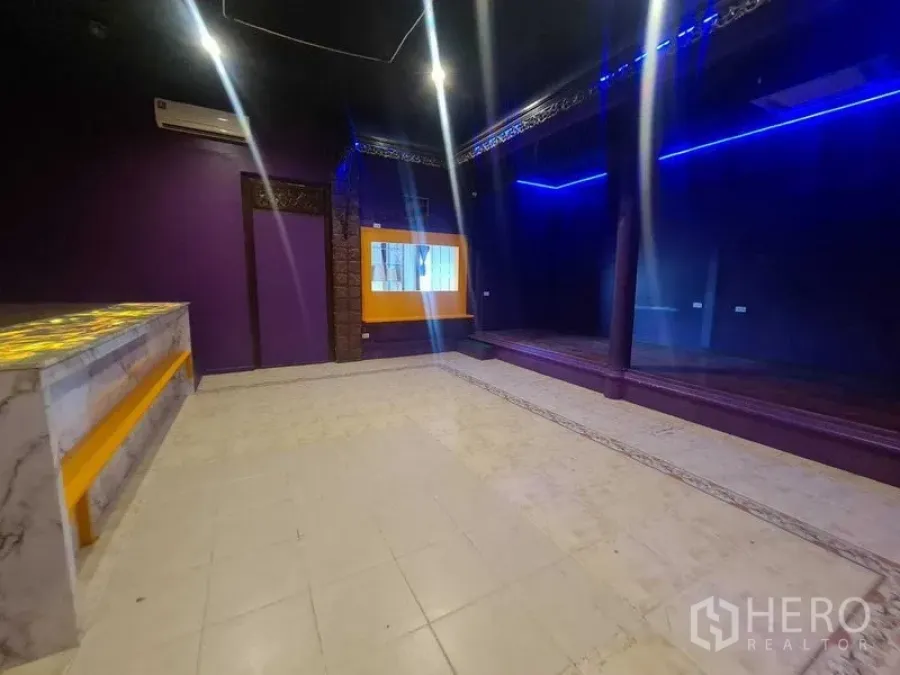 พื้นที่ขายปลีก ให้เช่าในWatthana, Bangkok - ห้องค้าปลีกผนังเงาคล้ายกระจก พร้อมเวทีและหน้าต่างกรอบสีเหลืองข้างเคาน์เตอร์