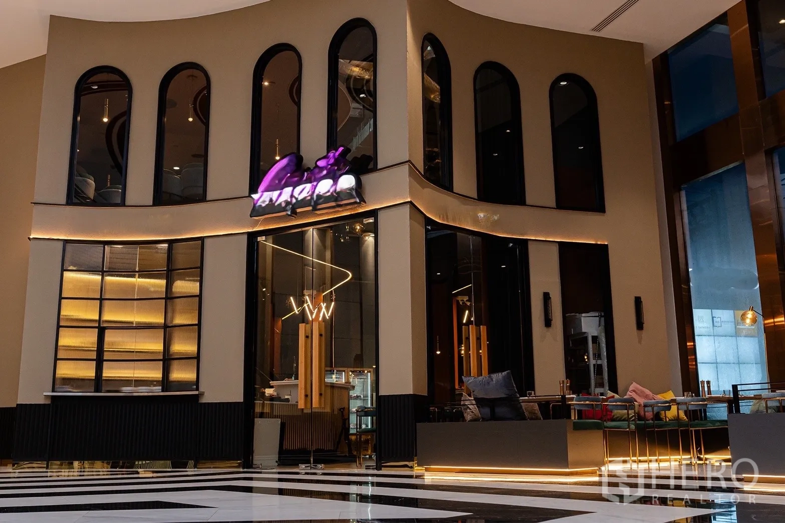 Retail Space for rent in Bang Rak, Bangkok - Stylish restaurant-style storefront with curved walls, dark frames, and interior seating.