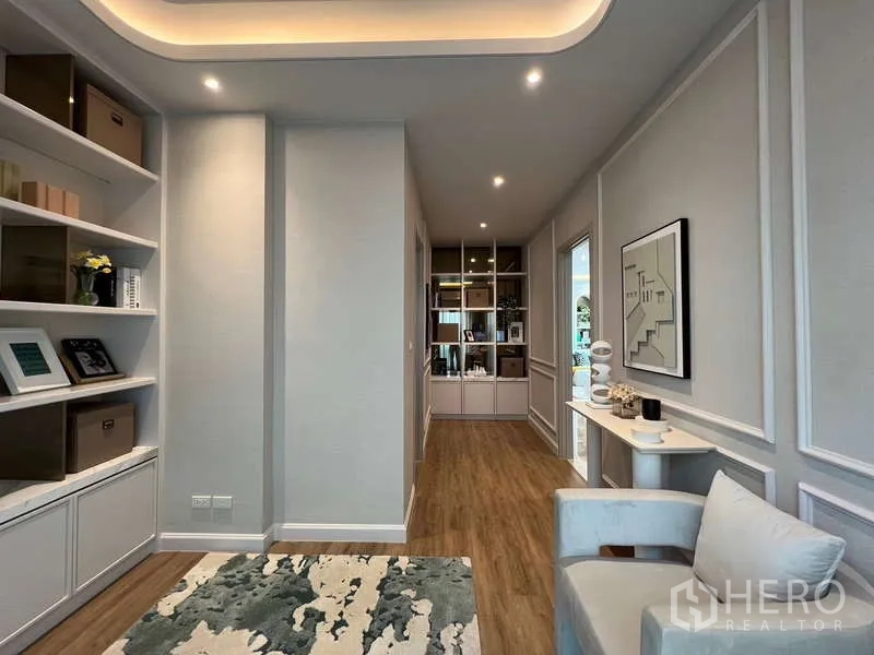 Detached House for sale in Saphan Sung, Bangkok - Upper-floor family lounge with statement chandelier, large windows and wood flooring.