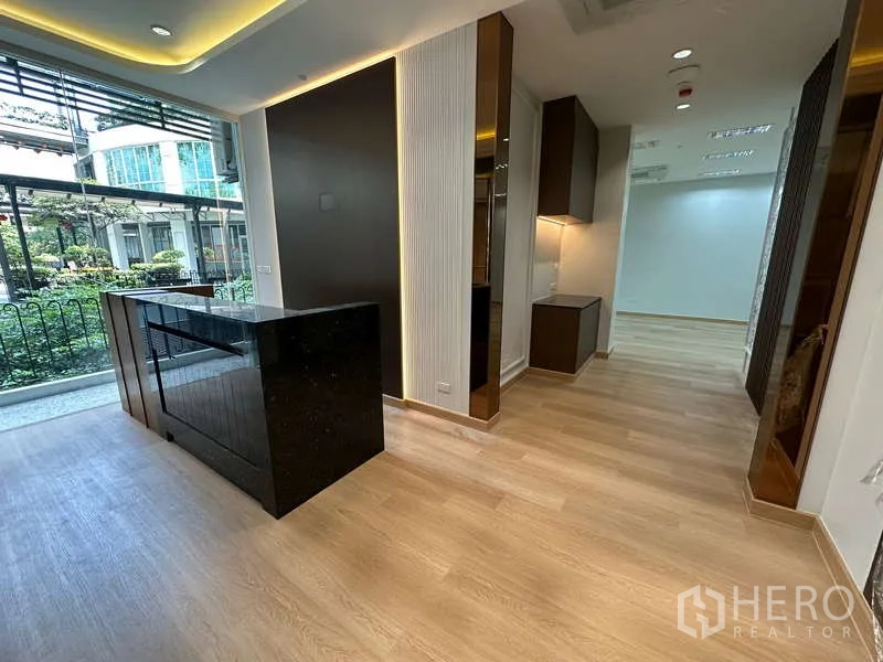 Office Space for rent - Reception counter by window overlooking landscaped courtyard and modern building.