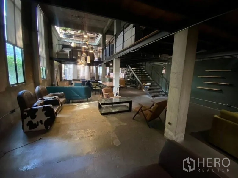 Retail Space for rent in Bang Na, Bangkok - Double-height industrial space with pendant lights and seating areas