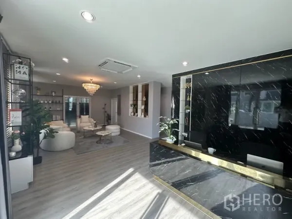 Factory for sale in Lam Luk Ka, Pathum Thani - Stylish reception area with black marble counter, seating and bright windows.